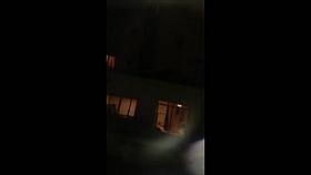 Chick undressing in window voyeur video clip