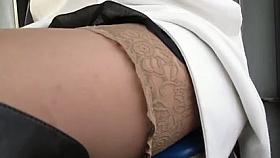 Playgirl in nylons and dark leather boots in a bus