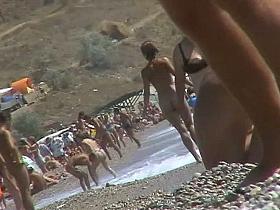 Short-haired girl with trimmed pussy relaxing at the nudist beach