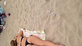 Black thong laying down on beach