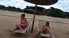 Super horny girls masturbating at the beach