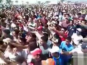 Chicks dance for a big audience of frat boys