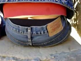 Cute bitch in tight jeans gives a peek of her ass