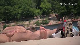 A shy fox with a seductive body stands slim on a beach in a porno