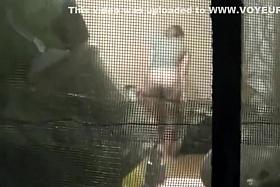 Peep an attractive girl through a window