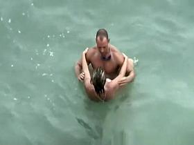 Tattooed nudist fucked in the water