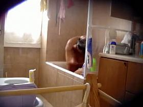 Brunette cutie gets shot by a hidden camera while taking a long sensual shower