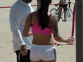 Busty fit girl does a beach workout