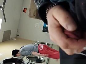 Guy plays with his cock in the laundry place