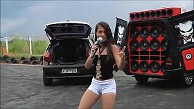 Teen Latina dancing and singing in a parking lot