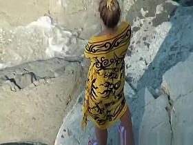 Nudist woman takes off her black bikini