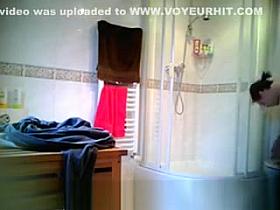 Teen changing tampon in bathroom