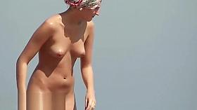 Superb voyeur beach video of a trimmed pussy tanning