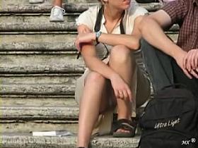 Hot girl provides upskirt view of her knickers on a stairway