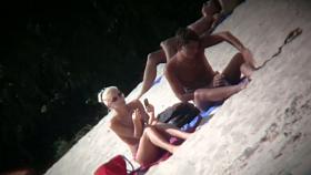 A couple sizzling hot blondes tanning in a nudist beach porno