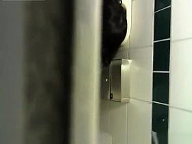 Over the toilet wall women caught peeing