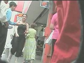 Enticing ass in a short skirt on an upskirt spy cam video