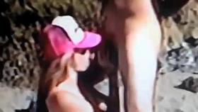 Hot redhead fucks on a public beach.