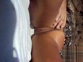 I stroke my naked girlfriend on the beach