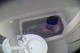 Curvy Asian cutie gets naked before a spy cam in the shower