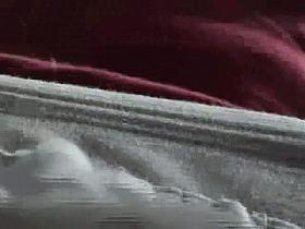 A super hot babe is talking on the street phone as a voyeur gets his chance for upskirt videos