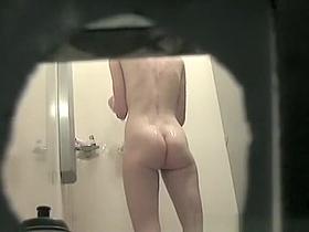 Woman in shower cabin washing her tight body