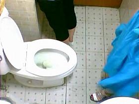 Two pretty Asian friends are pissing on toilet in café