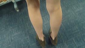 Slim blonde MILF upskirted in the library
