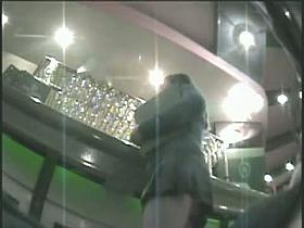 Sexy barmaid gives us an upskirt view of her butt