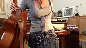 Redhead playing guitar down blouse and cleavage