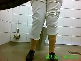 Squatting ladies pee in a public toilet