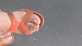 Teen with beautiful feet in the tramway