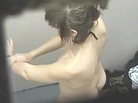 Nude dressing room girl covers the body with aroma spray