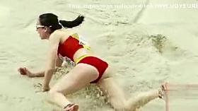 Raven-haired athletic babe competes in long jump