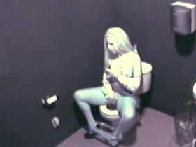 Blonde in high heels and lingerie rubs pussy in toilet voyeur