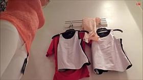 Girl is in the changing room willing to try on new cloths