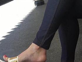 Sexy feet at London tube station, red toes dangling feet