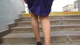 Girl in seameg stockings going upstairs