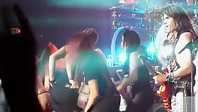 Groupies dancing and stripping at a hair metal show