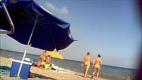 Ravishing woman strips out of a tight red dress in the sun