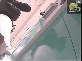 A public upskirt voyeur clip of a girl's bum in black thong