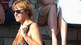 Look under the skirt of a woman who is sitting on the steps