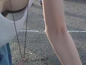 Girl in loose top uncovering her black bra downblouse