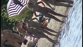 Nude beach filled with hot babes and an unsuspicious voyeur