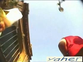 Lush bottomed redhead gives us an upskirt view of her panties