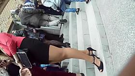 Hidden camera video of a girl in a tight black skirt waitin