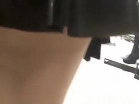 Exhibitionist wife in short latex skirt bending over