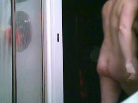 Unaware wife getting undressed