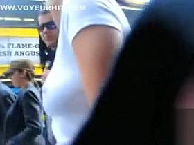 Braless brunette filmed on the street with her hard nipples