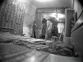 Woman undresses in bedroom